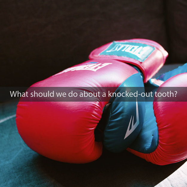 Red and blue boxing gloves on teal surface with text about knocked-out tooth treatment