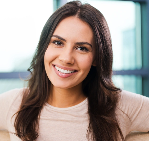 Smiling young woman representing enamel shaping and contouring services at Dentistry of Old Town Scottsdale