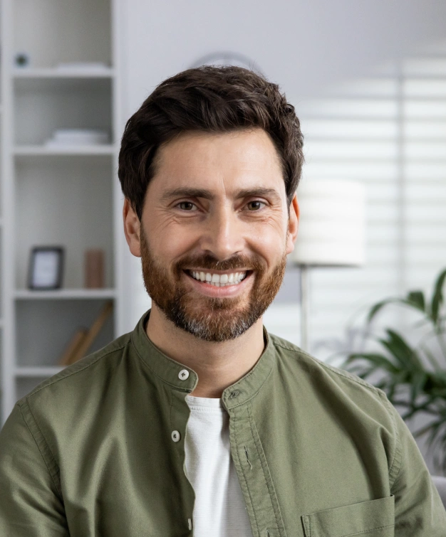 Smiling man with a beard representing hybrid prosthesis dental services at Dentistry of Old Town Scottsdale