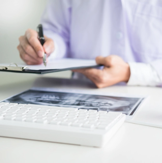 Patient reviewing paperwork with a dental team member representing dental insurance and financing options in Scottsdale