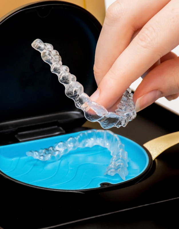Clear Invisalign aligners being held representing Invisalign orthodontic treatment at Dentistry of Old Town Scottsdale
