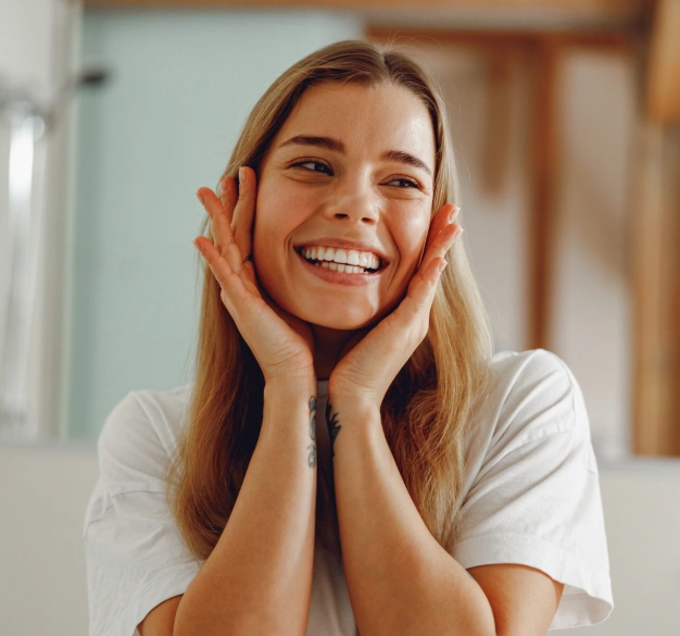 Smiling woman touching her face representing PDO smooth thread treatment services at Dentistry of Old Town Scottsdale