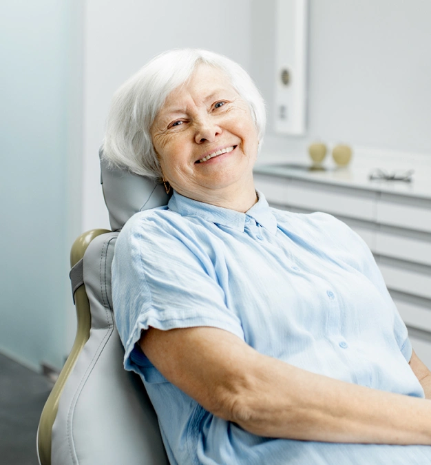 Older woman smiling in a dental chair representing root canal therapy services at Dentistry of Old Town Scottsdale