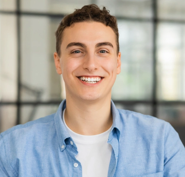 Smiling young man with bright white teeth representing teeth whitening services at Dentistry of Old Town Scottsdale