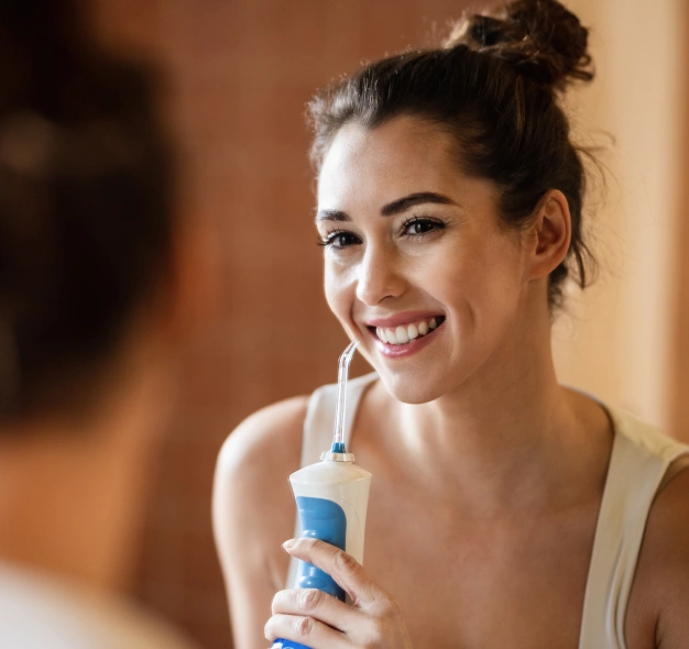 Smiling young woman representing Waterpik water flosser recommendations at Dentistry of Old Town Scottsdale