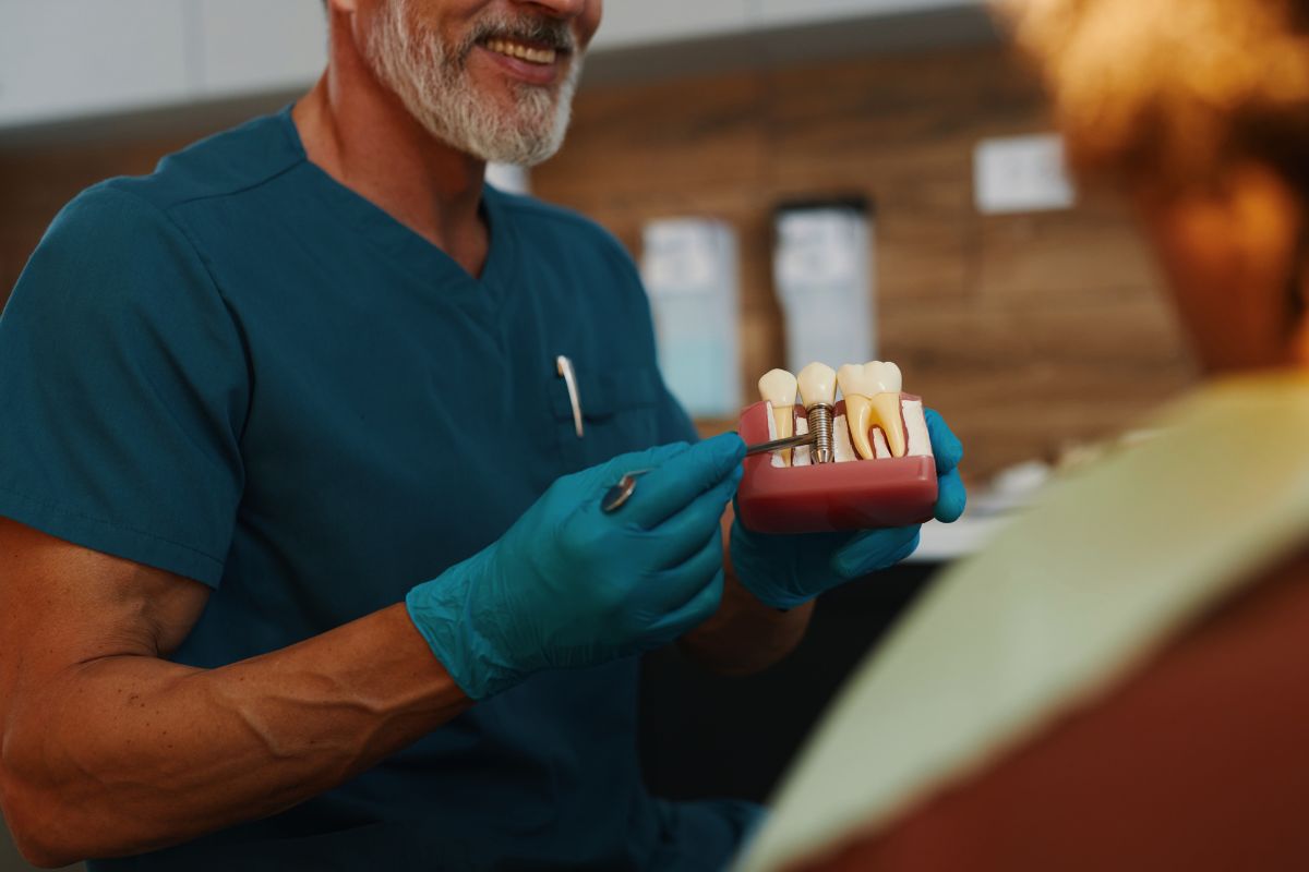 prosthodontist-in-scottsdale-az-explaining-about-dental-implants-procedure Prosthodontist in Scottsdale expalining to patient about dental implants