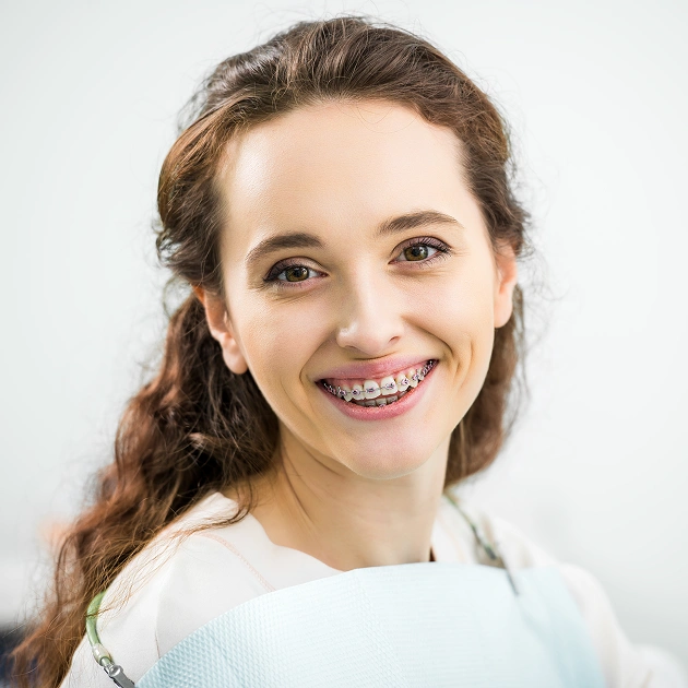 Smiling young woman representing lingual braces orthodontic treatment at Dentistry of Old Town Scottsdale