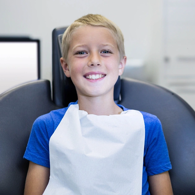 Young girl smiling in a dental chair representing nitrous oxide sedation for children at Dentistry of Old Town Scottsdale