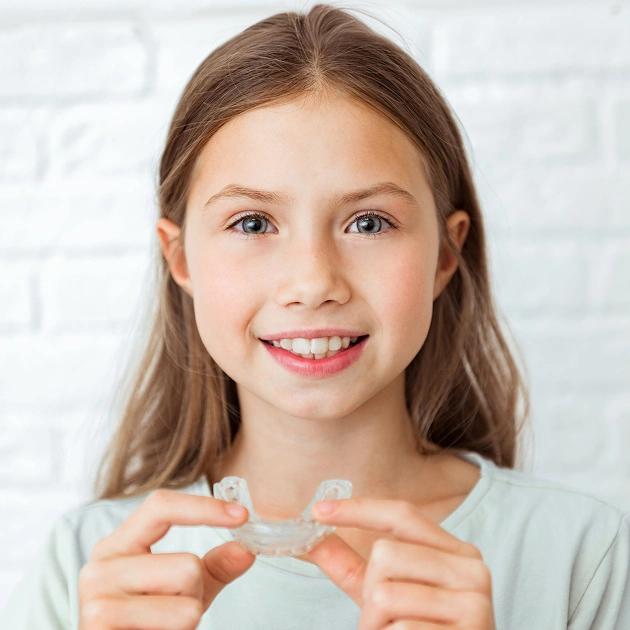 Smiling young girl representing orthodontic mouthguard services for children at Dentistry of Old Town Scottsdale