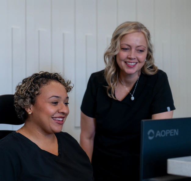 Dental team member smiling at the front desk representing patient services at Dentistry of Old Town Scottsdale