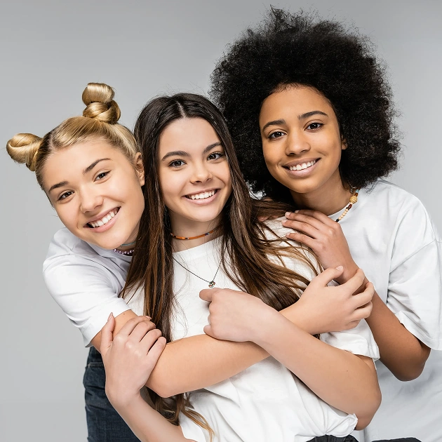 Three smiling women representing GLO teeth whitening treatment at Dentistry of Old Town Scottsdale