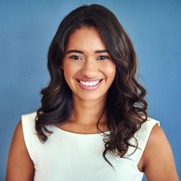 Smiling young woman with natural hair representing teeth whitening services at Dentistry of Old Town Scottsdale