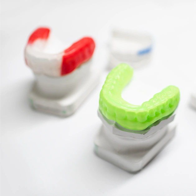 Colorful Under Armour athletic mouthguards representing custom sports mouthguard services at Dentistry of Old Town Scottsdale
