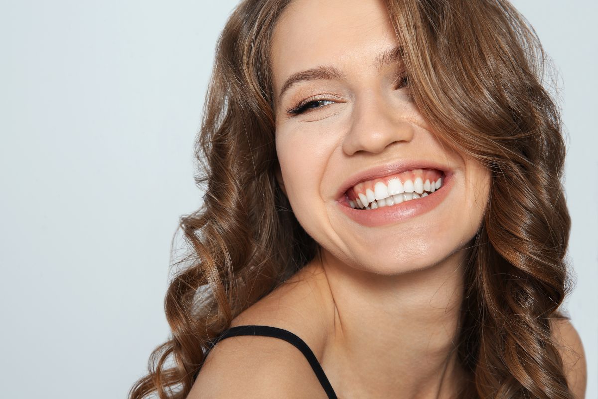 Woman smiling with an even, straight smile after cosmetic dentistry in Scottsdale