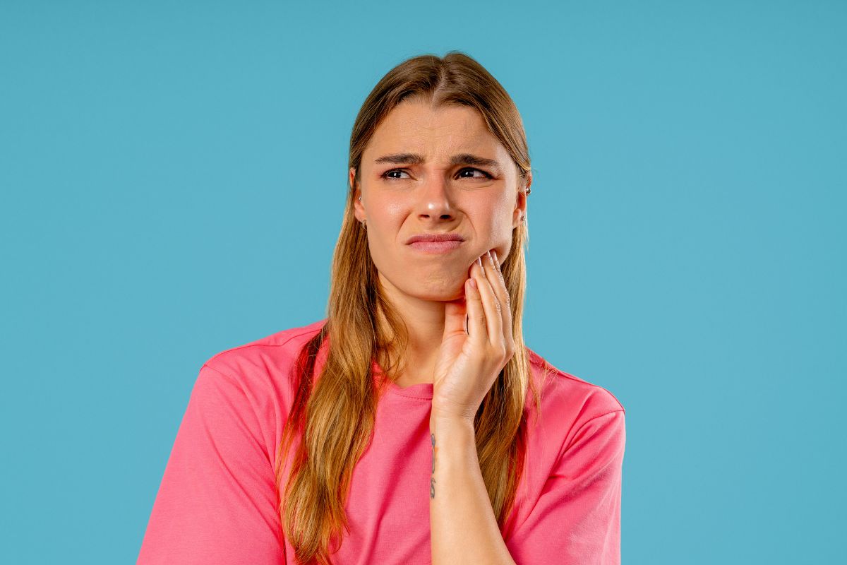 Woman experiencing Sudden Tooth Pain before visiting an Emergency Dentist Scottsdale
